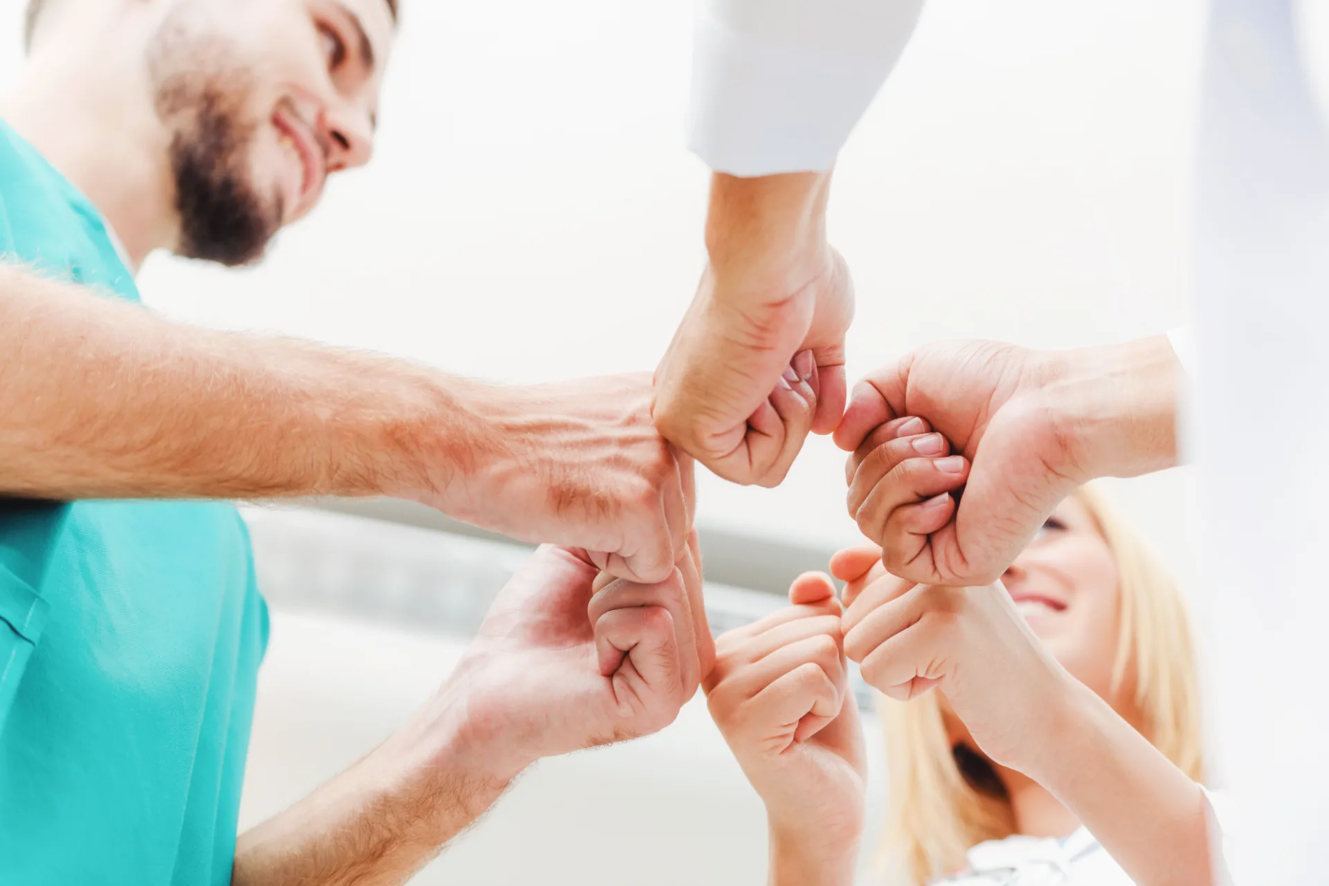 A care team putting their hands together